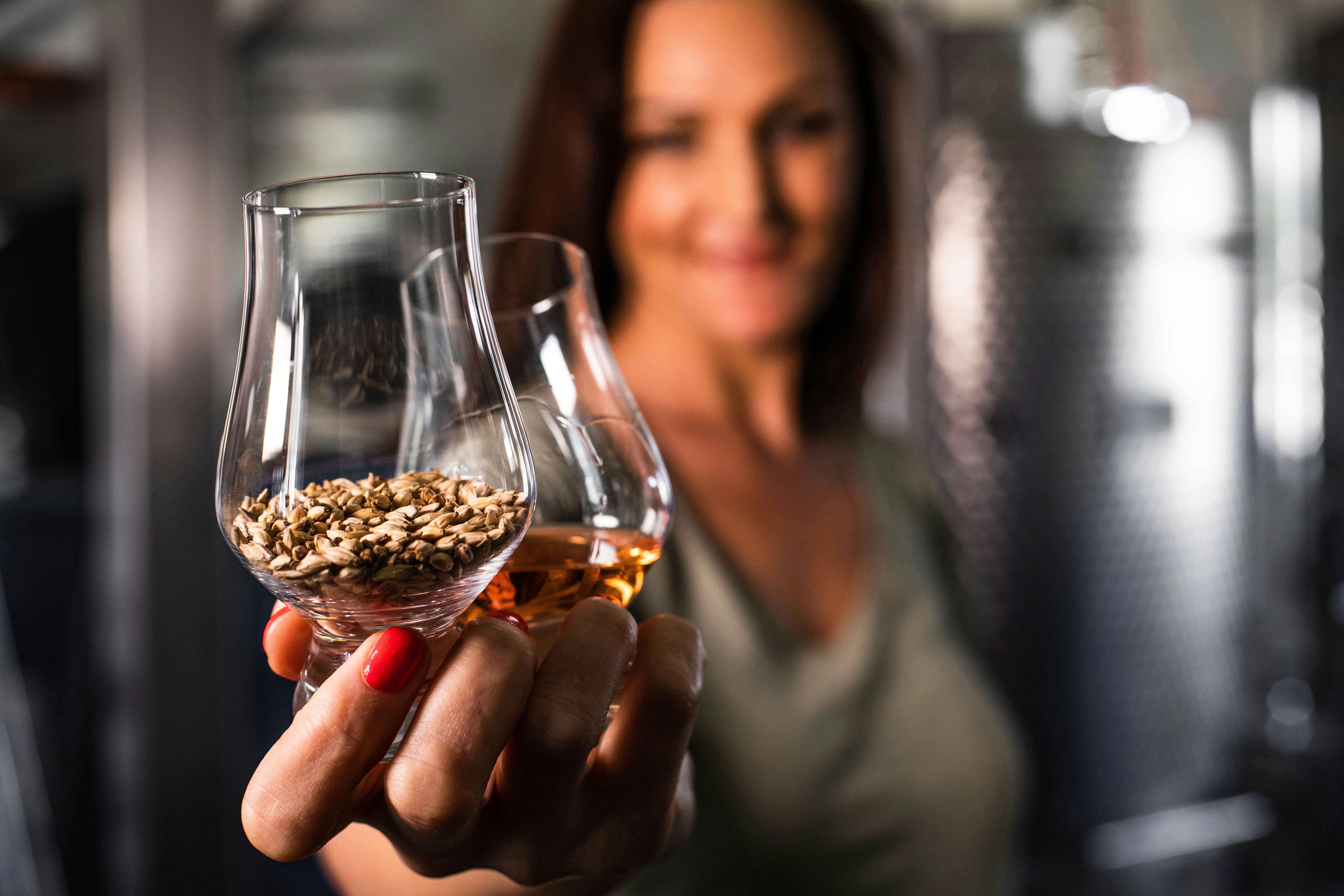 woman holding clear glass cup